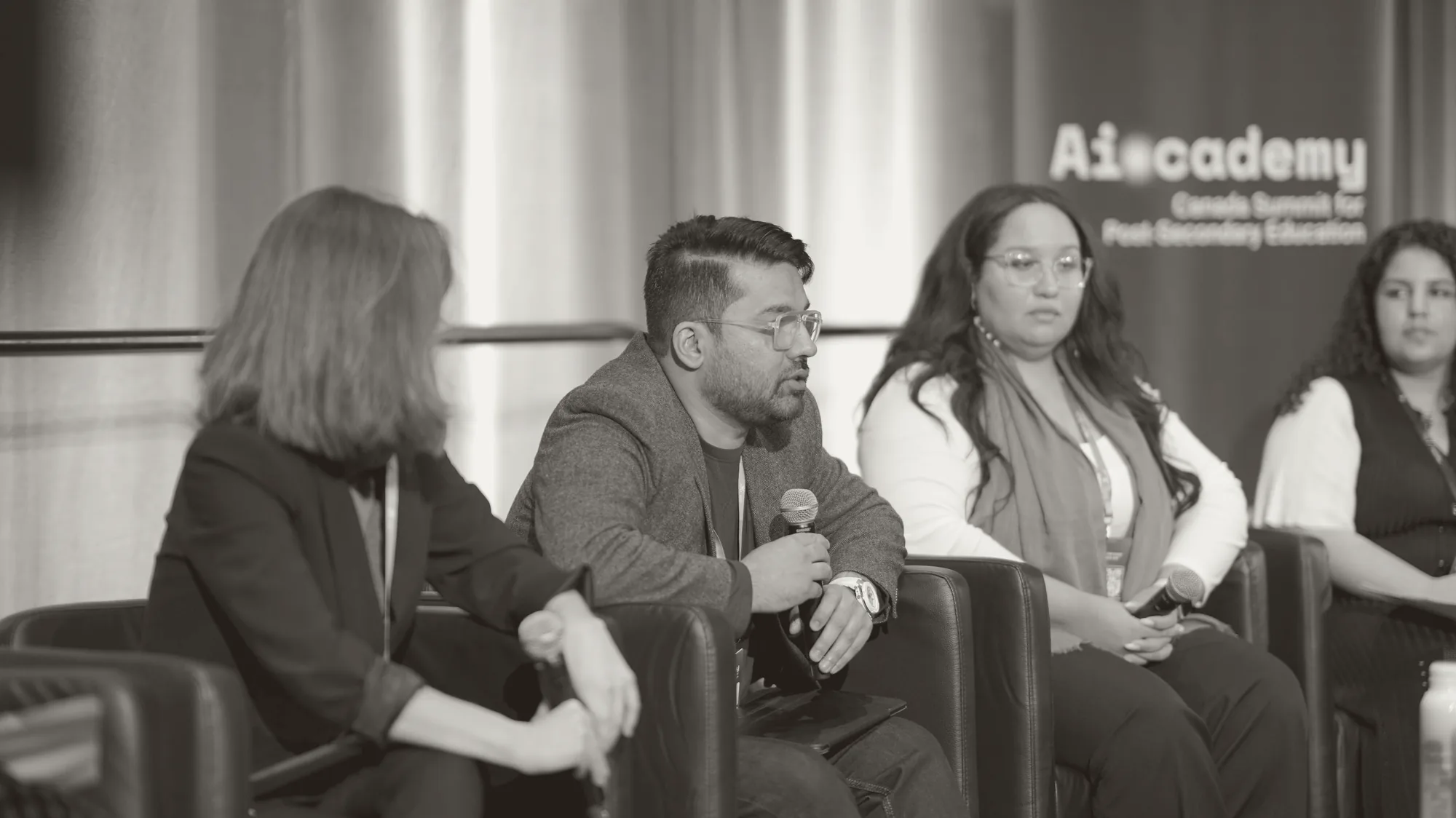 Muhammad Haseeb Arshad speaking on a panel at the AI-CADEMY Canada Summit for Post-Secondary Education, seated with four other panellists.